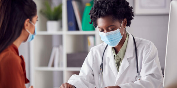 Female,Doctor,In,White,Coat,Wearing,Face,Mask,Having,Meeting