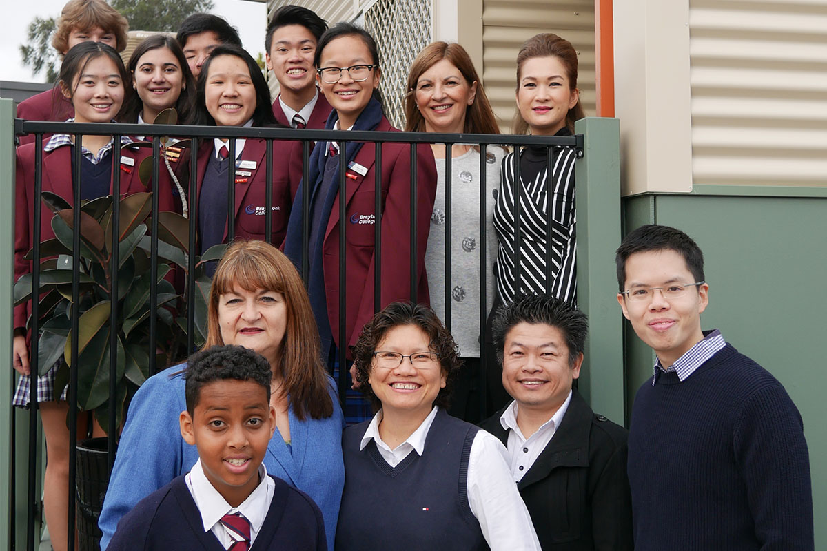 Students, staff and doctors pose for a photo at a participating school in the Doctors in Secondary School program